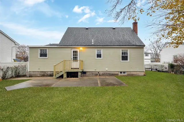 a backyard of a house with table and chairs