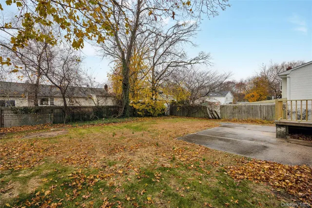 a view of a yard with wooden fence