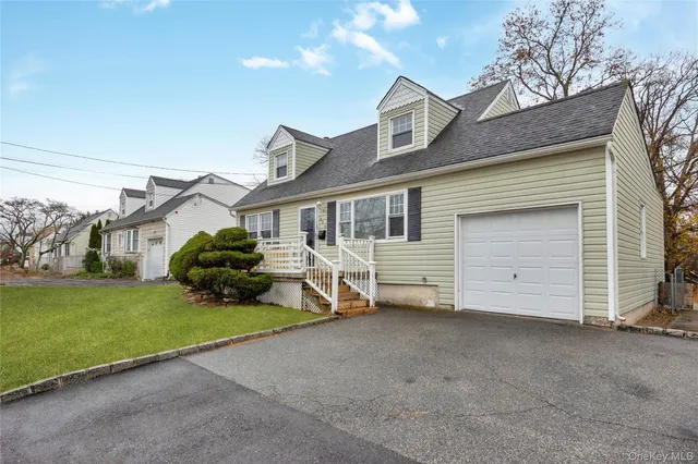 a view of a house with a yard and garage