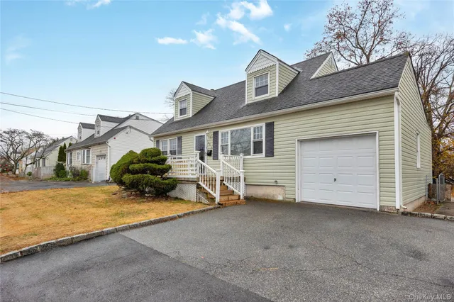 a view of a house with a yard and wooden fence