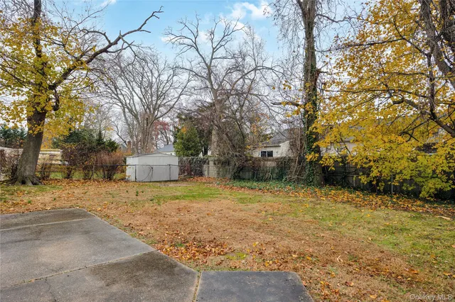 a backyard of a house with large trees