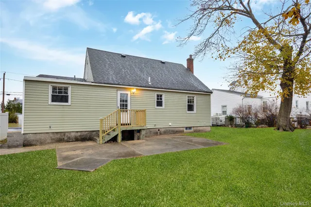 a backyard of a house with table and chairs