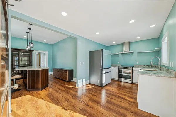a kitchen with stainless steel appliances granite countertop a sink stove and refrigerator