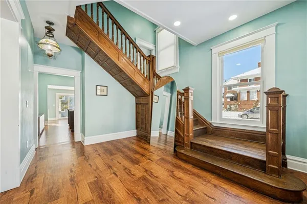 a view of entryway with wooden floor and stairs