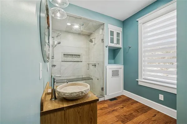 a bathroom with a granite countertop shower a sink and a toilet