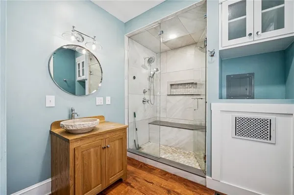 a bathroom with a sink a toilet and shower