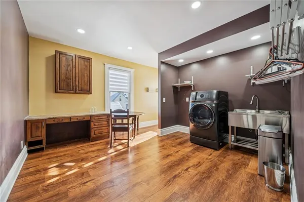 a living room with furniture a flat screen tv and a stove