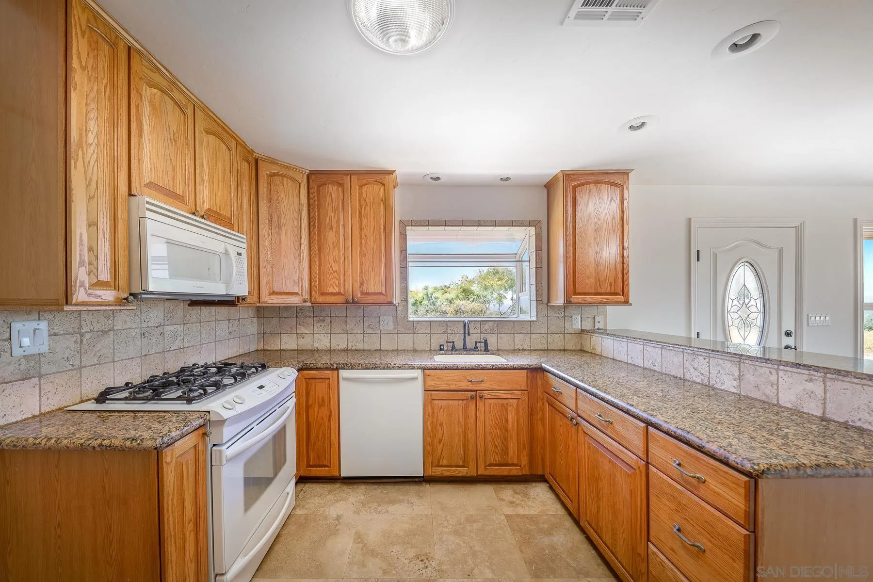 38960-62 Magee Road Pala, CA 92059 - Photo 9 of 25 a kitchen with stainless steel appliances granite countertop a sink stove and cabinets