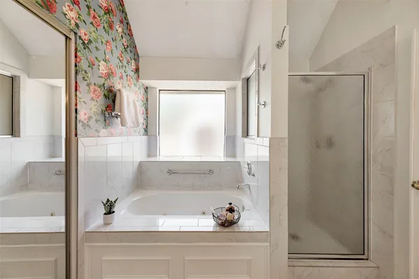 a bathroom with a bathtub and a shower