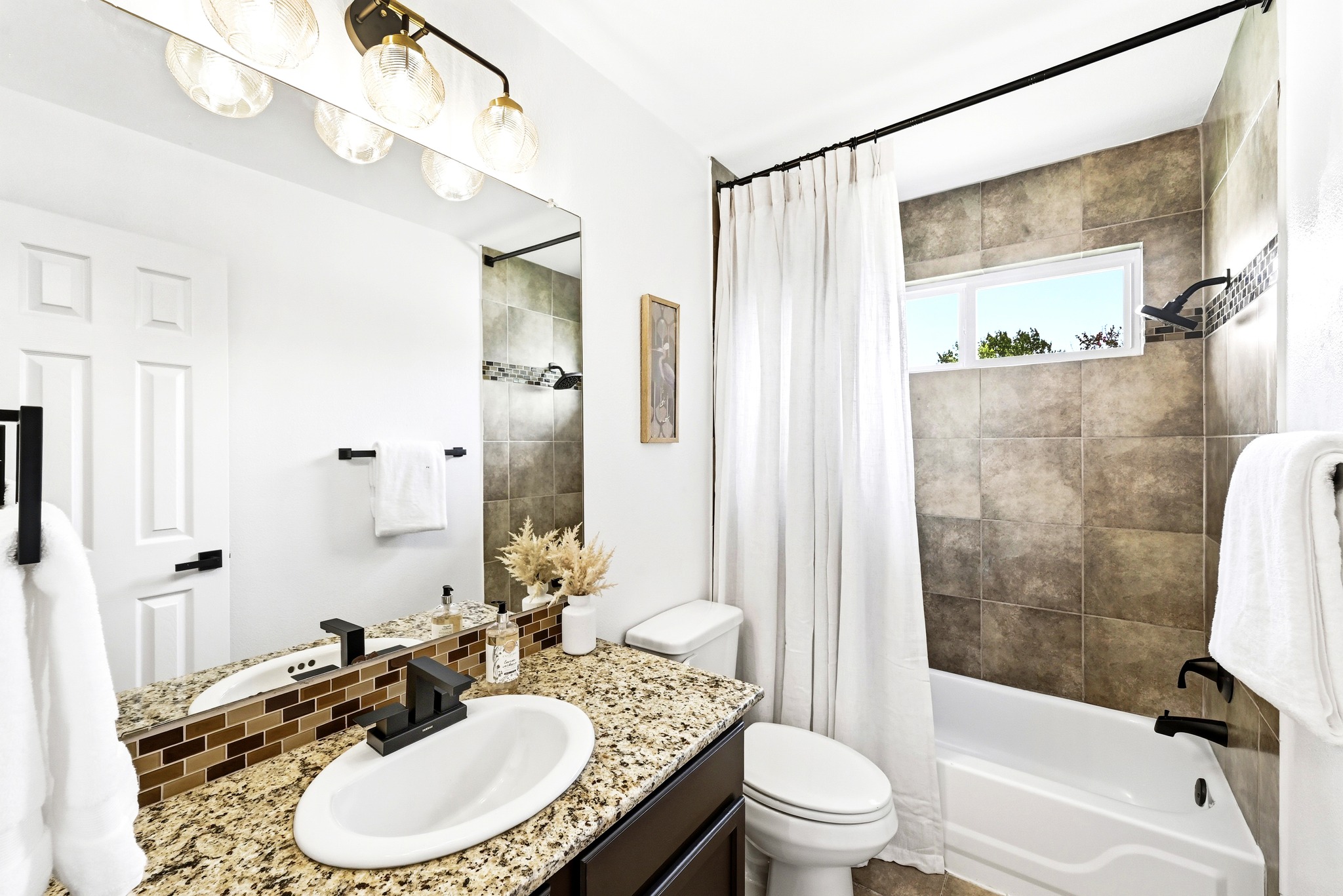 1801 Monks Tale Court Austin, TX 78748 - Photo 22 of 36 Elegant granite countertops and tiled shower create a refined bathroom oasis.