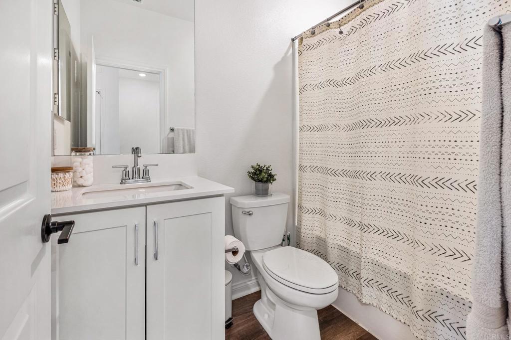1978 Affinity Lane Chula Vista, CA 91915 - Photo 16 of 26 a bathroom with a granite countertop sink toilet and shower