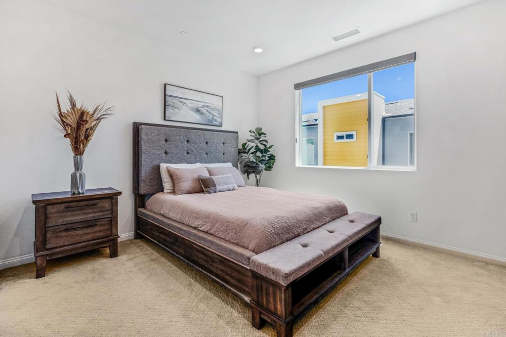 1978 Affinity Lane Chula Vista, CA 91915 - Photo 17 of 26 a bedroom with a bed and a potted plant