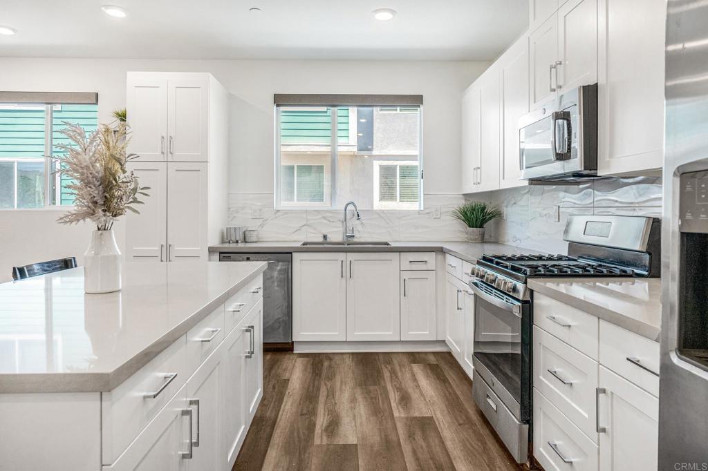 1978 Affinity Lane Chula Vista, CA 91915 - Photo 5 of 26 a kitchen with stainless steel appliances granite countertop a stove and a sink