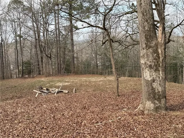 a view of a backyard with table and chairs