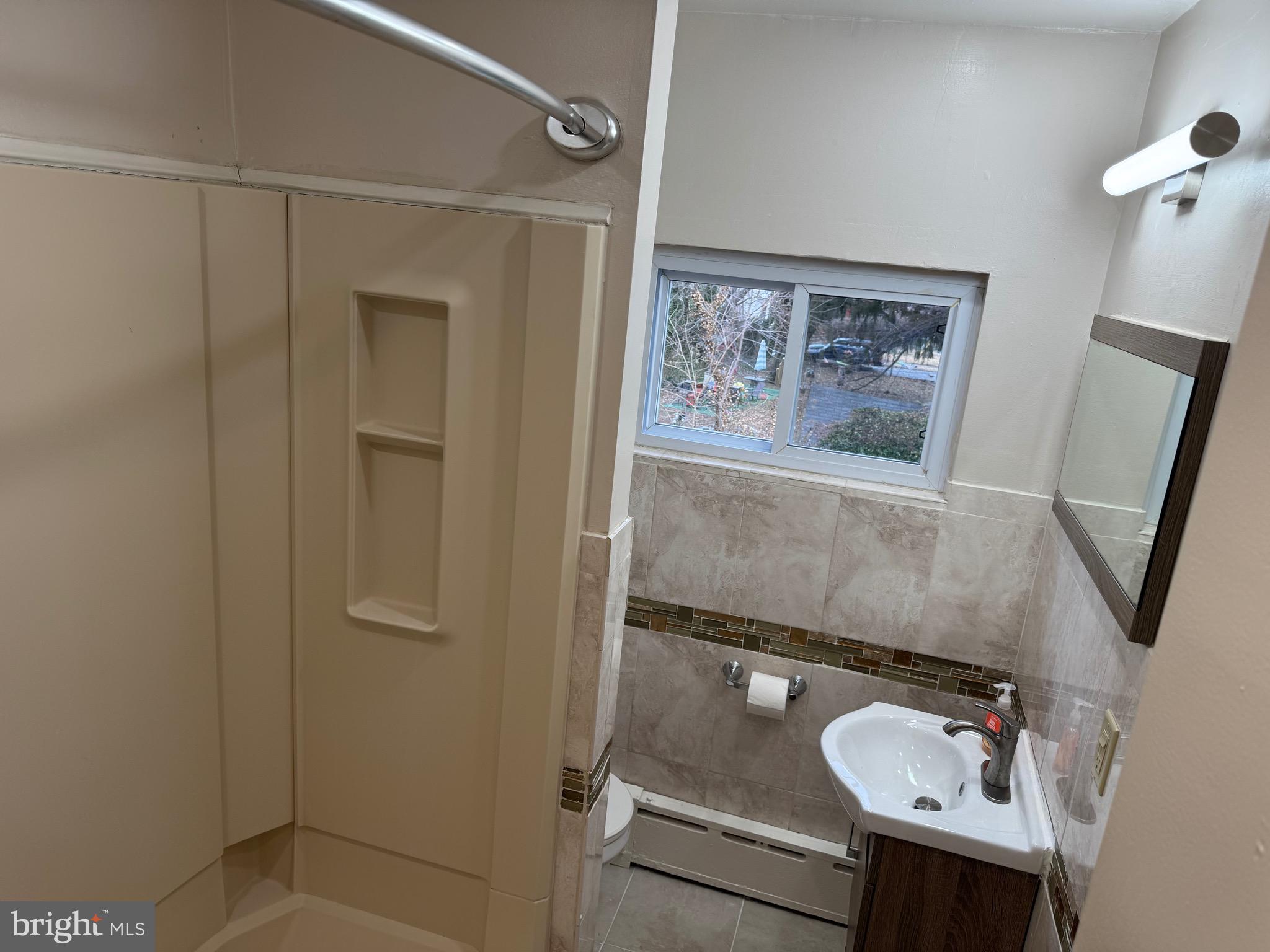 417 Laurel Road Lansdowne, PA 19050 - Photo 18 of 22 a bathroom with a sink and mirror