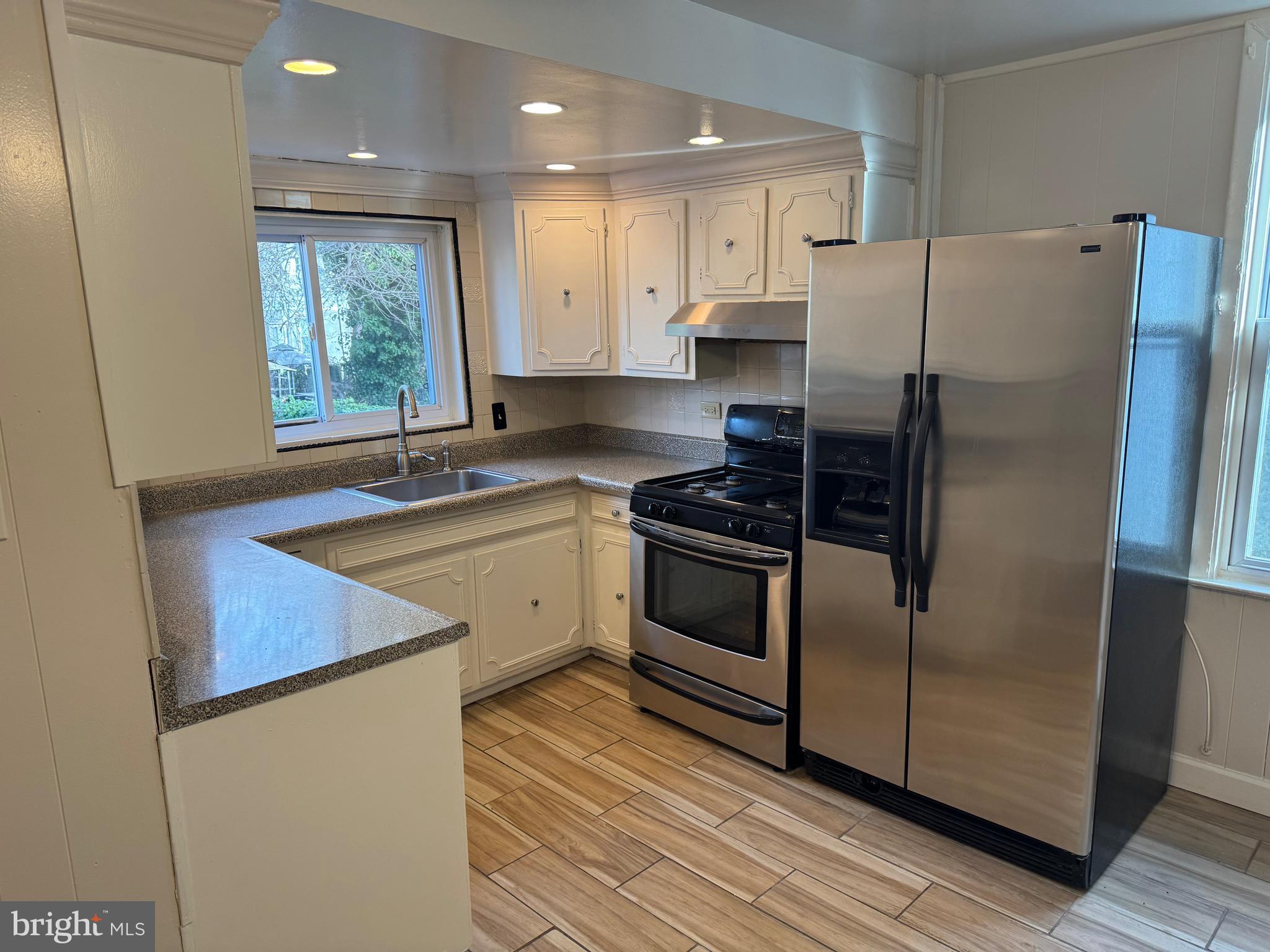 417 Laurel Road Lansdowne, PA 19050 - Photo 5 of 22 a kitchen with a refrigerator stove and sink