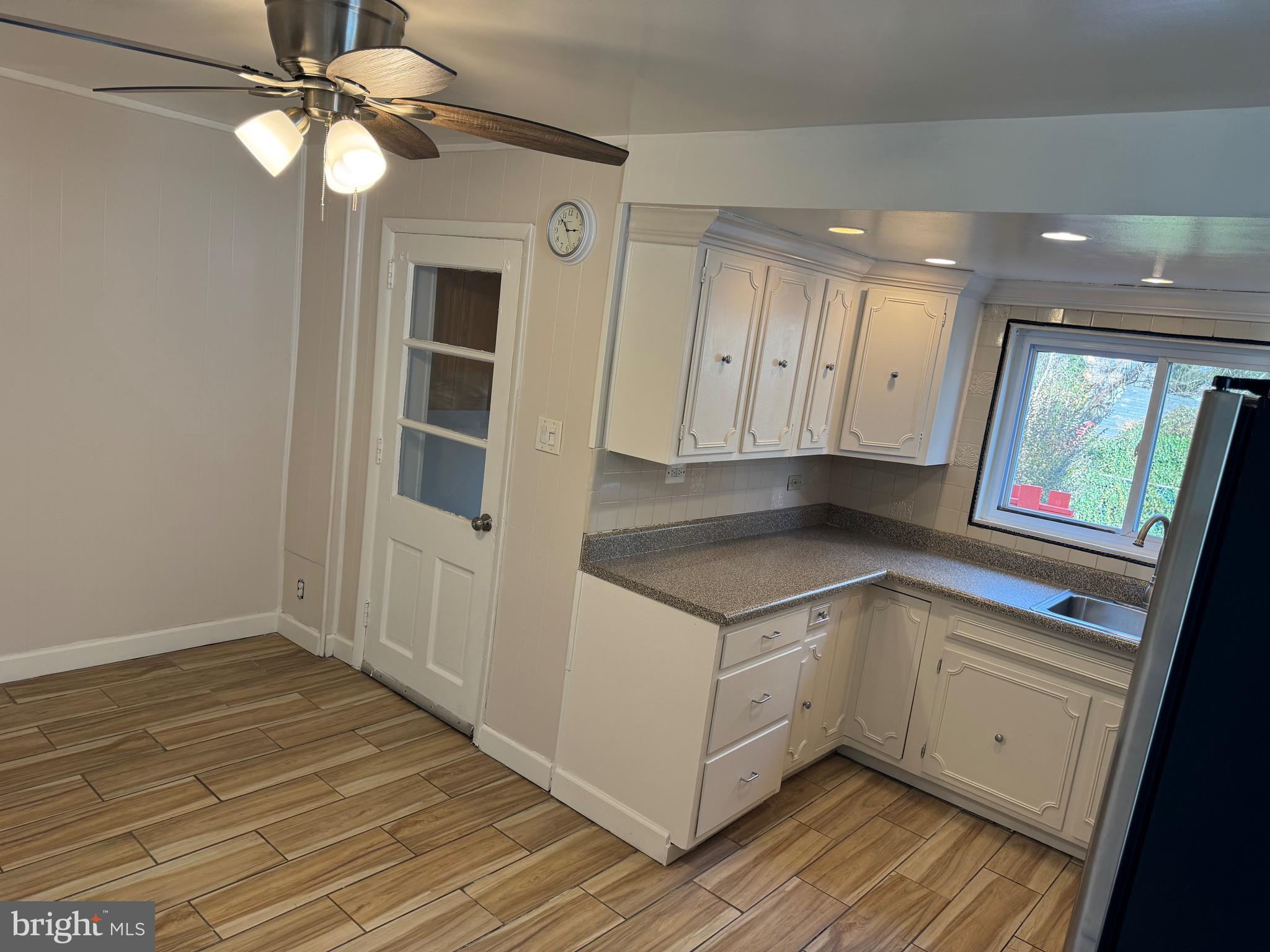 417 Laurel Road Lansdowne, PA 19050 - Photo 6 of 22 a view of kitchen with granite countertop cabinets and wooden floor