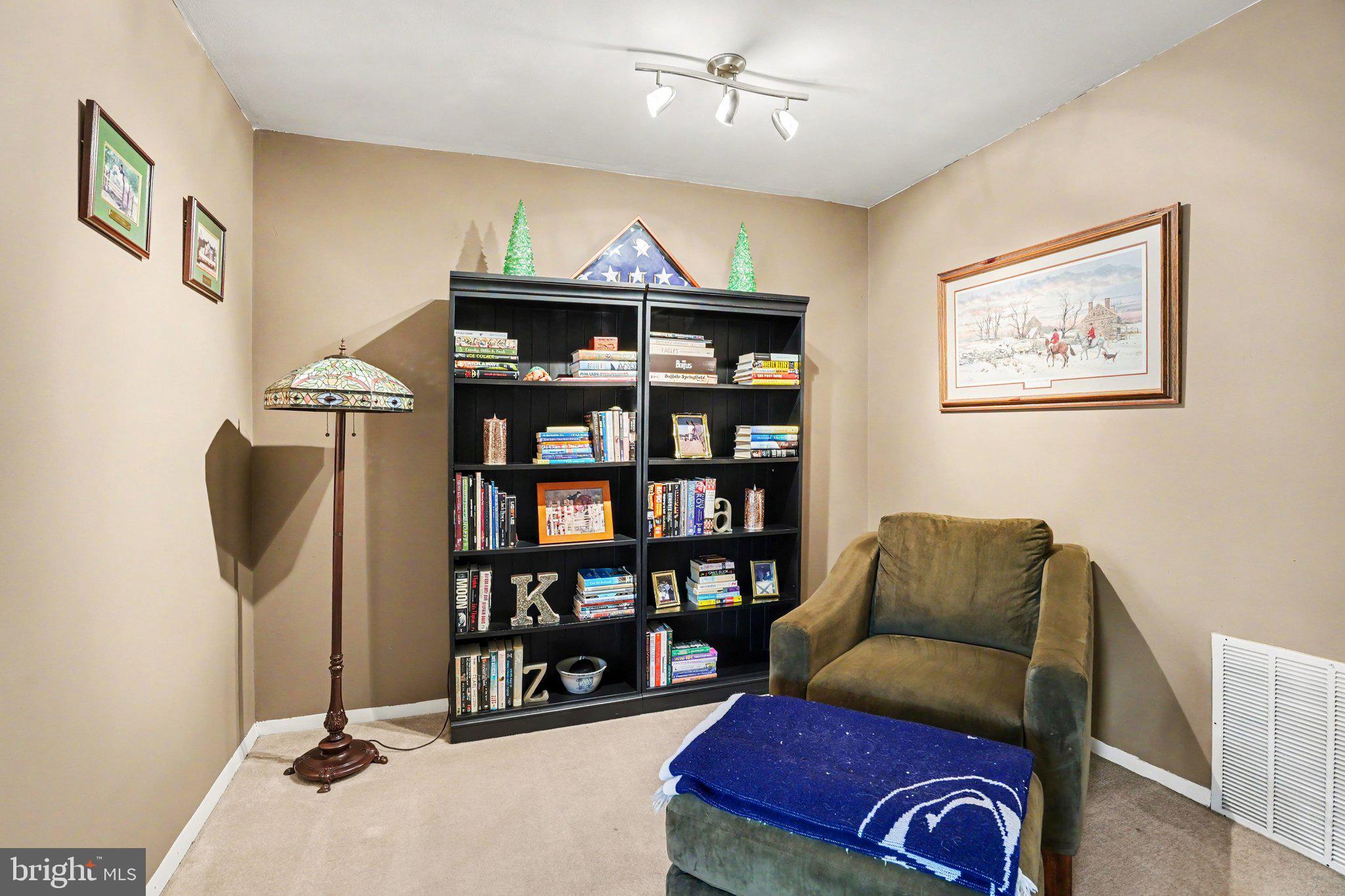 300 Lopax Road Harrisburg, PA 17112 - Photo 12 of 28 a living room with furniture a bookshelf and a book shelf