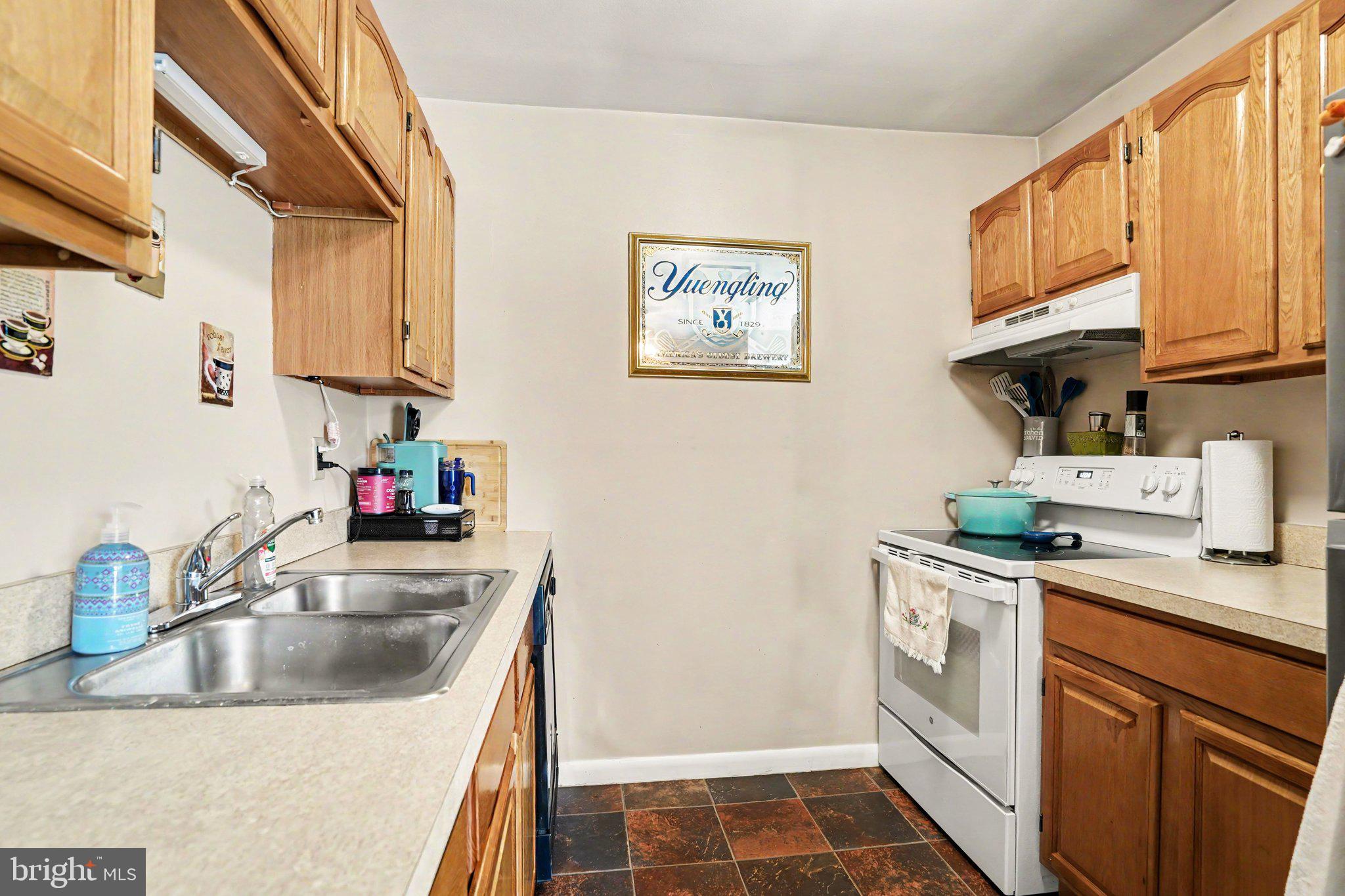 300 Lopax Road Harrisburg, PA 17112 - Photo 7 of 28 a kitchen with a sink stove and cabinets