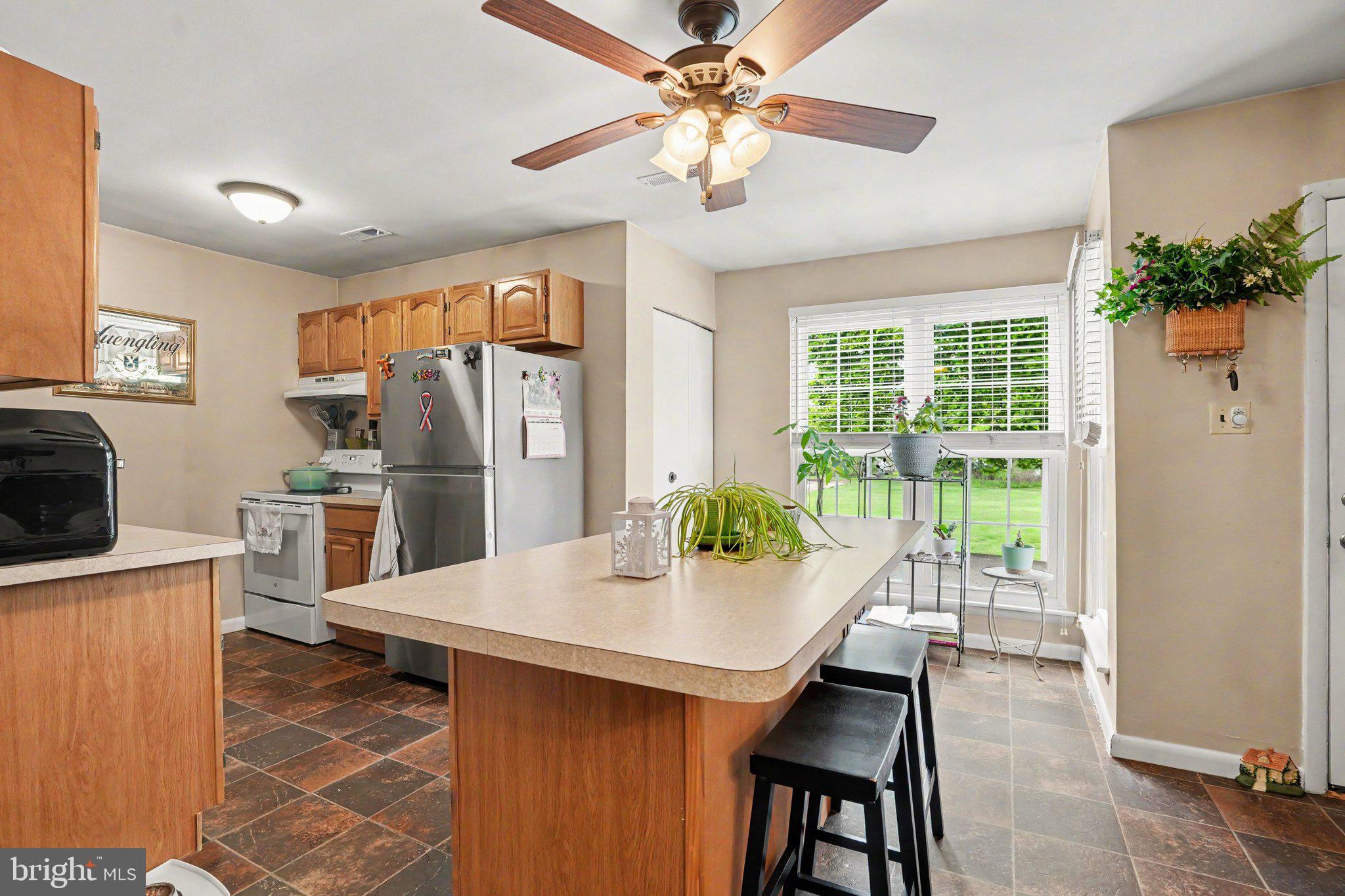 300 Lopax Road Harrisburg, PA 17112 - Photo 8 of 28 a kitchen with a table chairs refrigerator and microwave