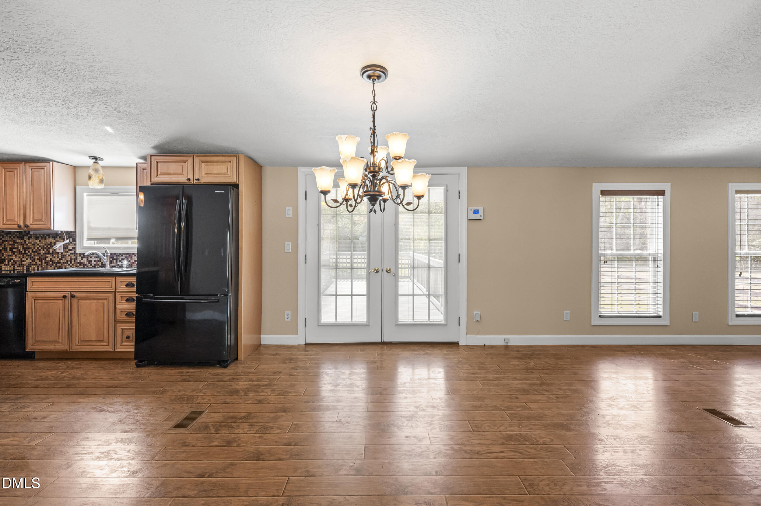 221 Pinkney Church Road Fremont, NC 27830 - Photo 26 of 36 a view of a kitchen with a refrigerator wooden floor and a window