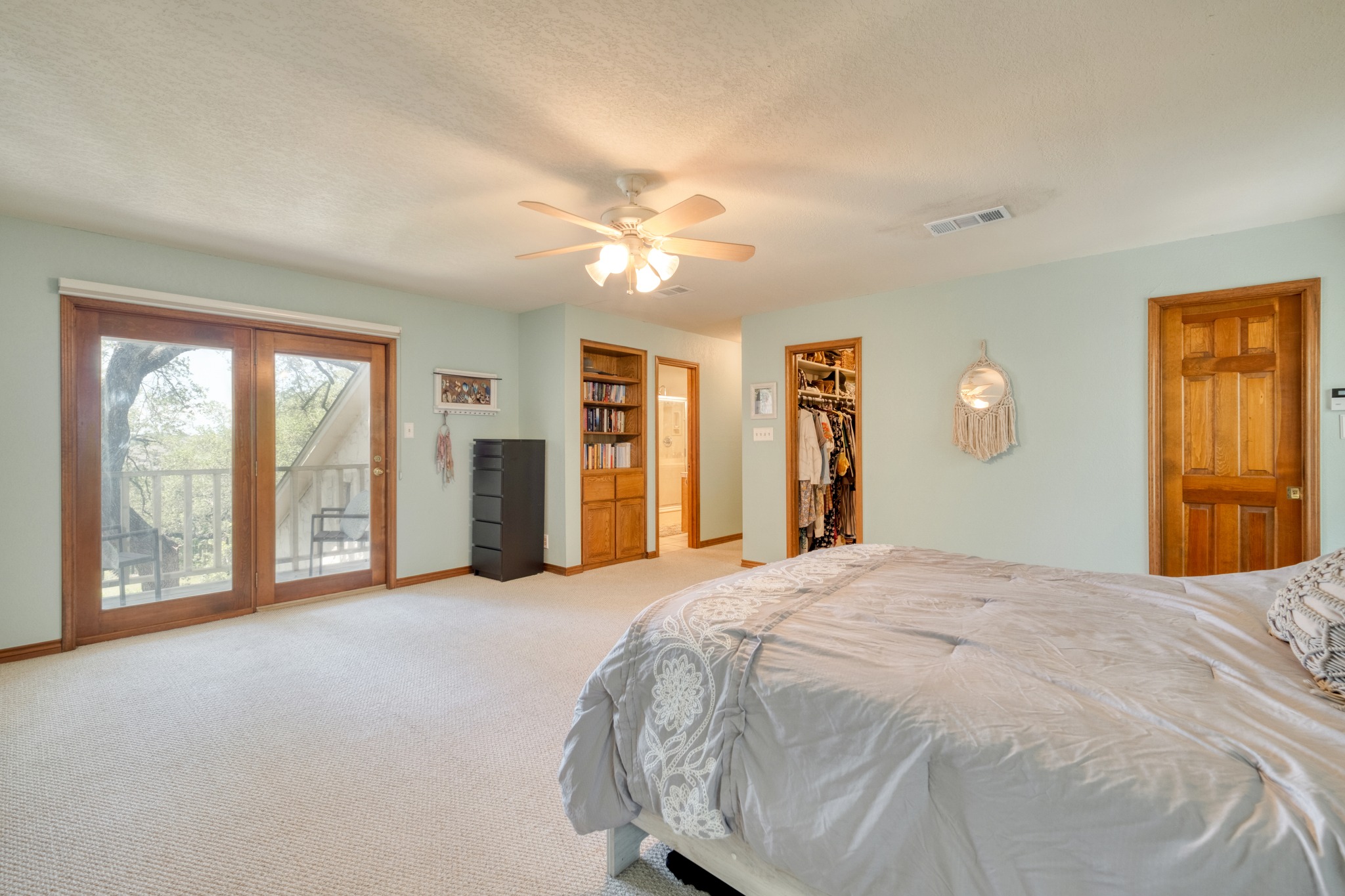 202 Ridgewood Drive Georgetown, TX 78628 - Photo 21 of 40 a spacious bedroom with a large bed and a chandelier