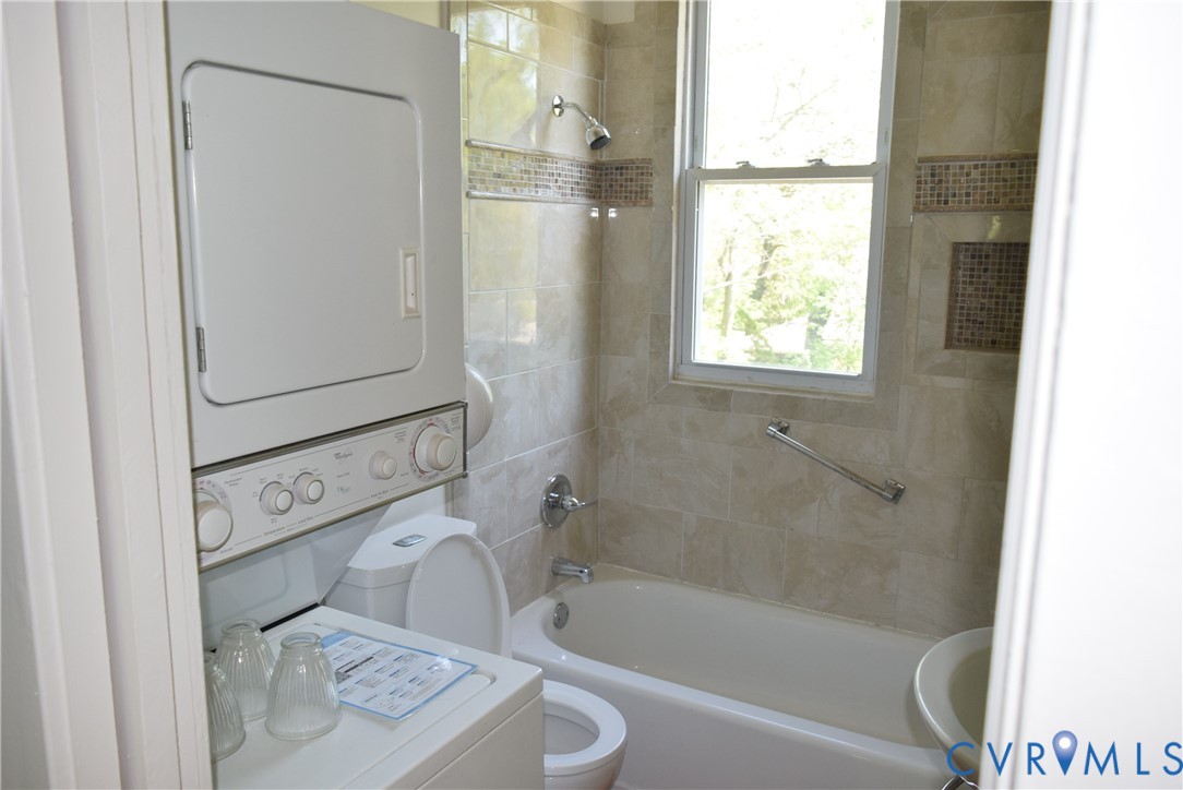 301 West 30th Street Richmond, VA 23225 - Photo 12 of 15 Full bathroom with stacked washer and clothes drye