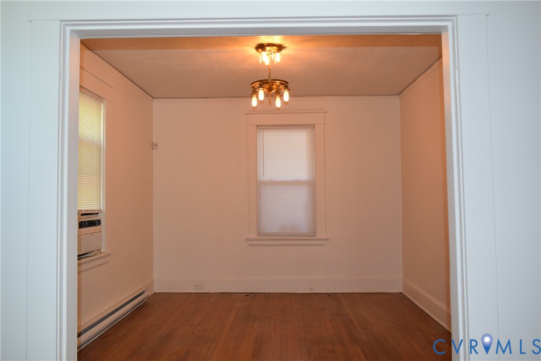 301 West 30th Street Richmond, VA 23225 - Photo 3 of 15 Empty room with a baseboard radiator, wood finishe