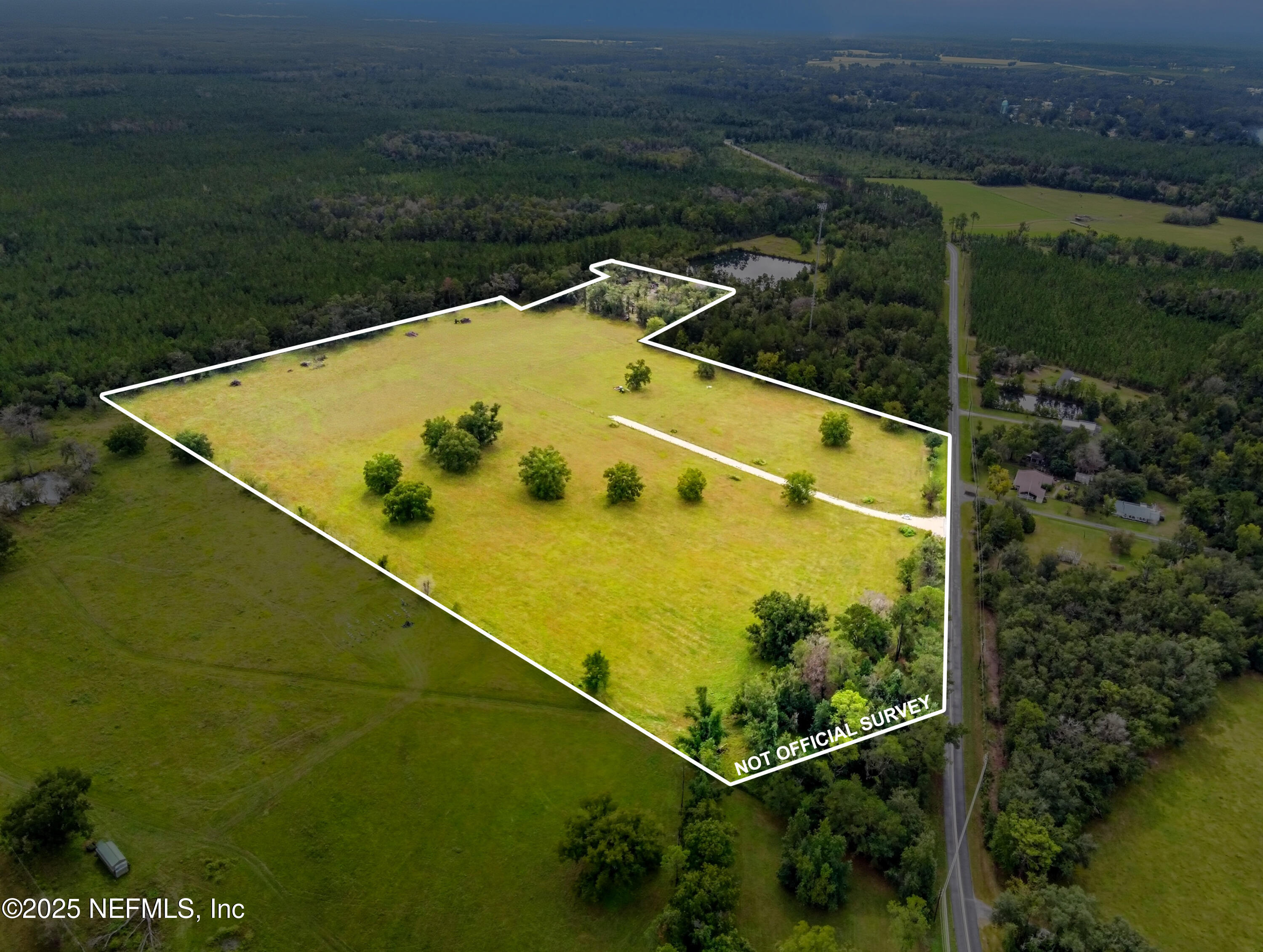 11242 Hogan Road Live Oak, FL 32060 - Photo 22 of 39 a view of a swimming pool with a yard