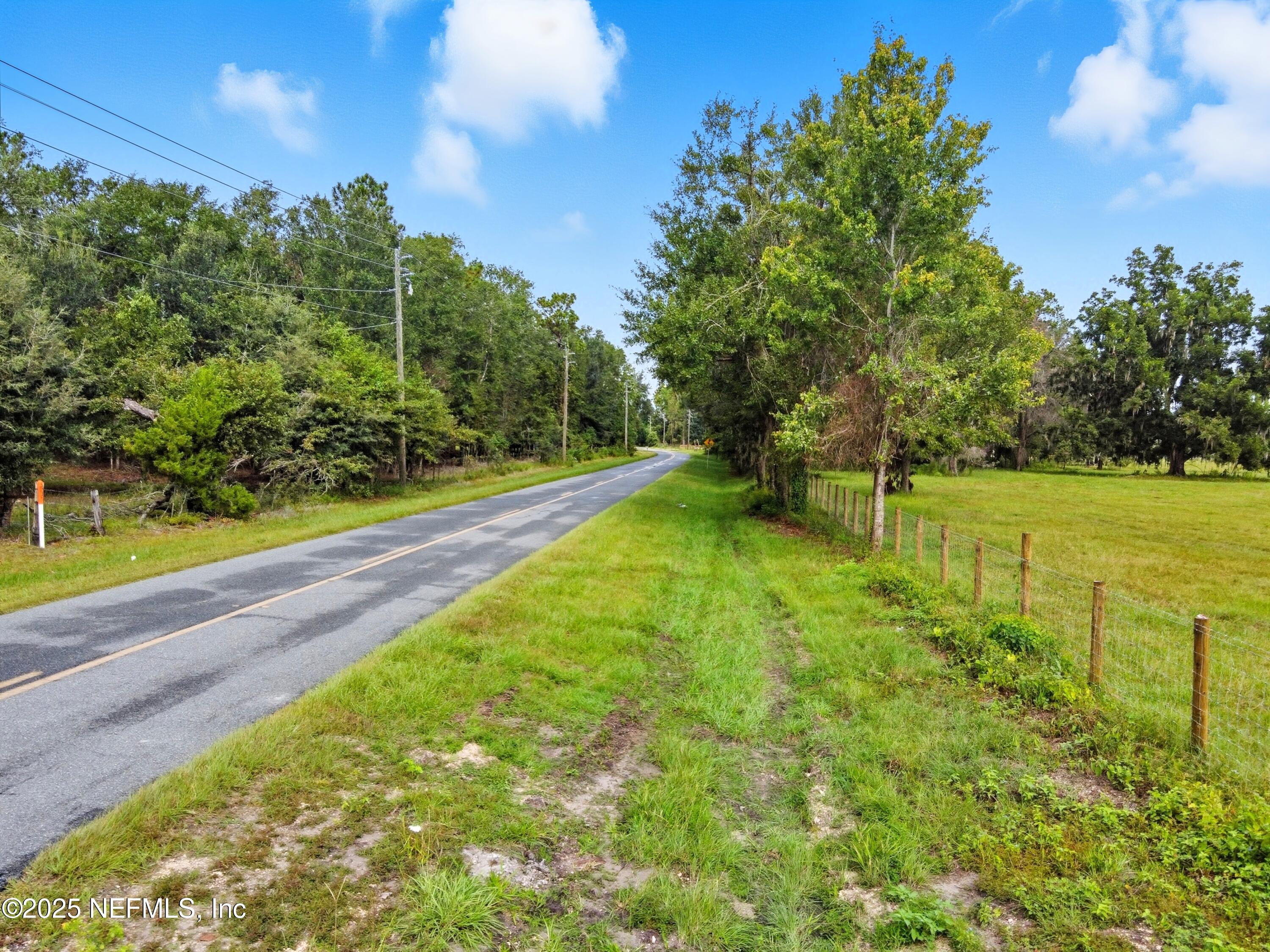11242 Hogan Road Live Oak, FL 32060 - Photo 39 of 39 a view of yard with swimming pool and trees in the background