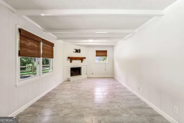 a view of a livingroom with an empty space and a fireplace