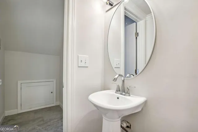 a bathroom with a sink a mirror and bathtub