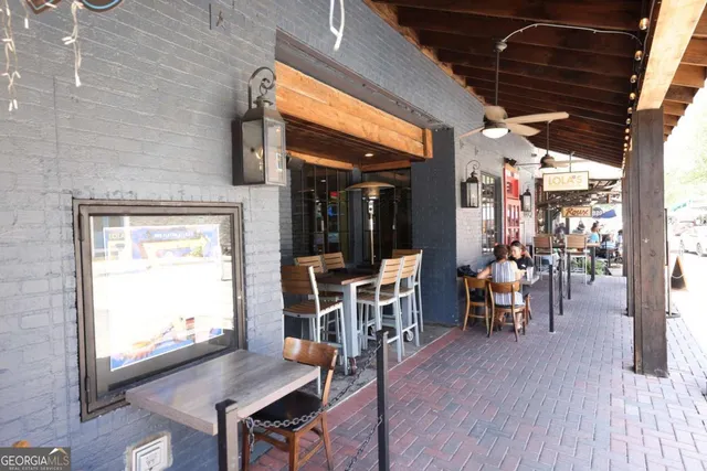 a view of a patio with table and chairs