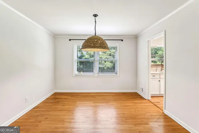 a view of a room window and wooden floor