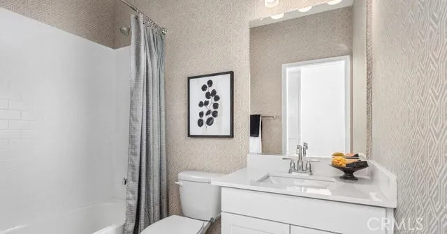 a bathroom with a sink toilet and mirror