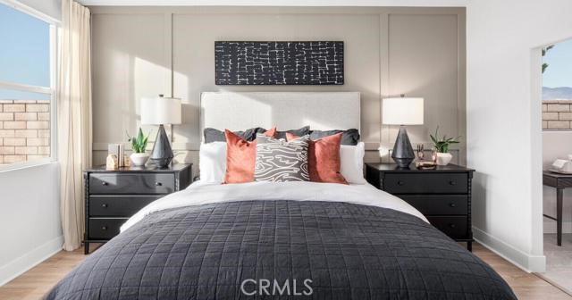 42409 Lamporo Way Indio, CA 92203 - Photo 14 of 24 a bedroom with a bed and wooden floor