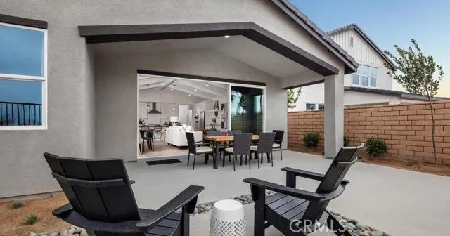 a dining room with furniture and a potted plant