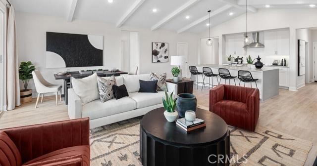 42409 Lamporo Way Indio, CA 92203 - Photo 3 of 24 a living room with furniture potted plant and kitchen view