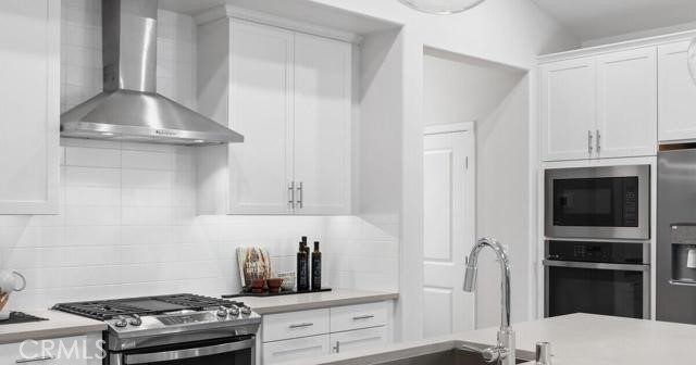 42409 Lamporo Way Indio, CA 92203 - Photo 8 of 24 a kitchen with stainless steel appliances granite countertop white cabinets and a stove