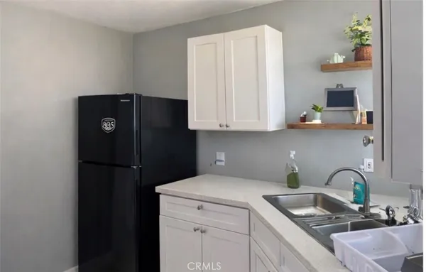 a kitchen with a refrigerator and cabinets
