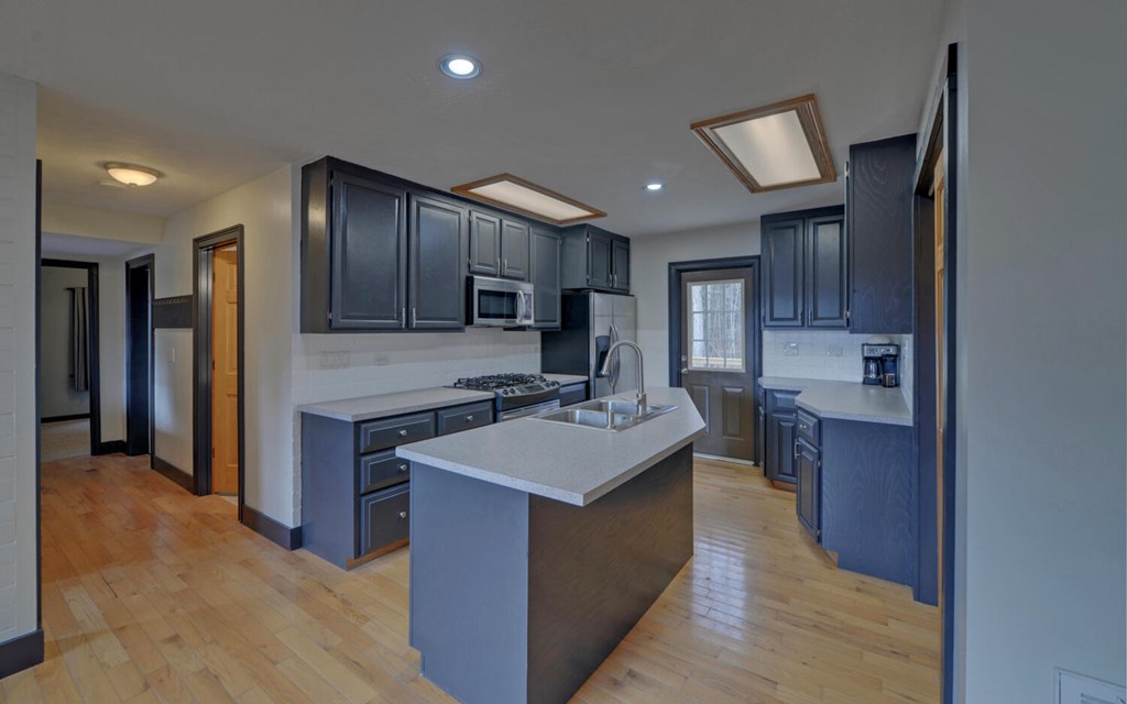 16 Bell Lane Morganton, GA 30560 - Photo 11 of 51 a kitchen with a stove sink and a refrigerator