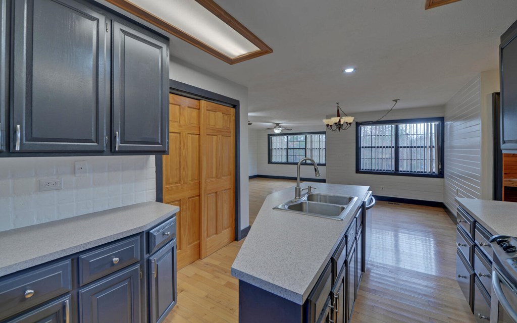 16 Bell Lane Morganton, GA 30560 - Photo 12 of 51 a kitchen with granite countertop a sink dishwasher stove top oven and wooden floor