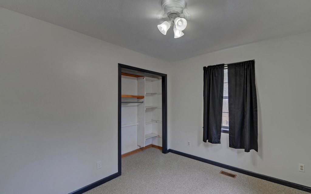 16 Bell Lane Morganton, GA 30560 - Photo 27 of 51 an empty room with closet and mirror