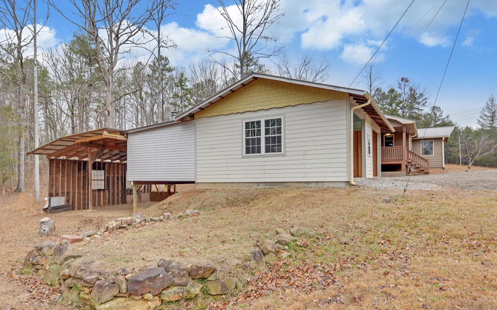 16 Bell Lane Morganton, GA 30560 - Photo 38 of 51 a backyard of a house with large trees and covered with snow