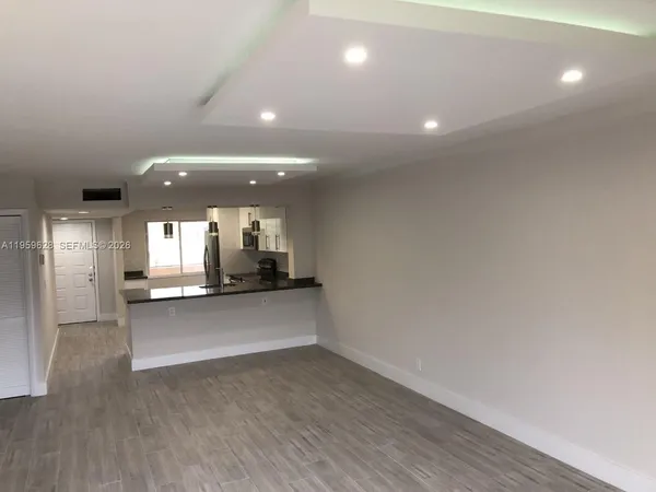a view of a kitchen with a sink and a window