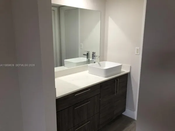 a bathroom with a sink and a mirror