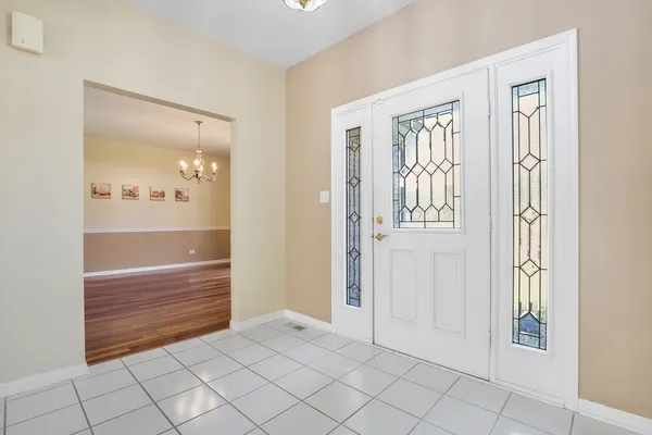 a view of an entryway with wooden floor
