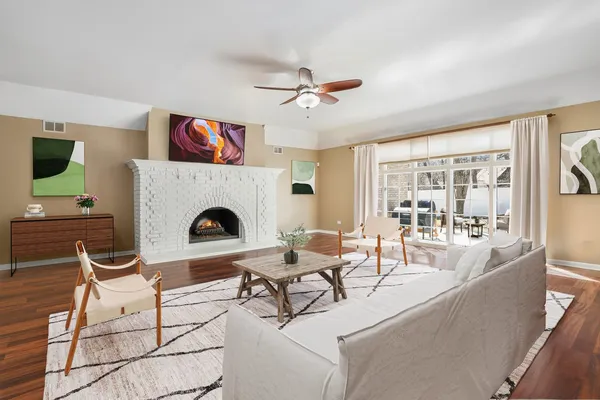a living room with furniture a fireplace and a flat screen tv
