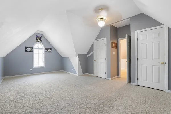 an empty room with windows and cabinet