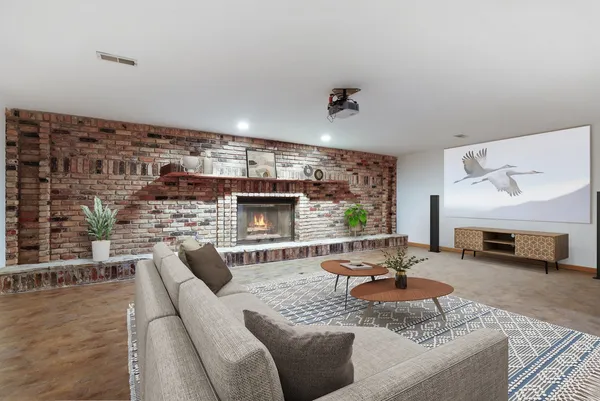 a living room with furniture and a fireplace